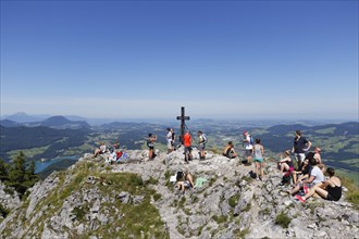 Hikers on the summit cross of the Schober