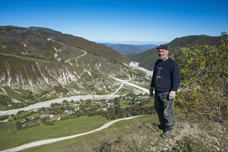 Old Chechen man at an overlook in the Chechen mountains