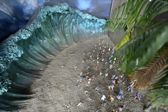 Model of the tsunami and people fleeing from the beach
