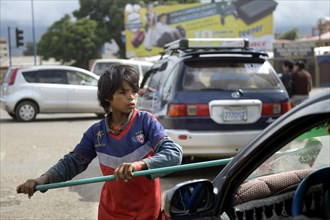 Street child cleaning windshield
