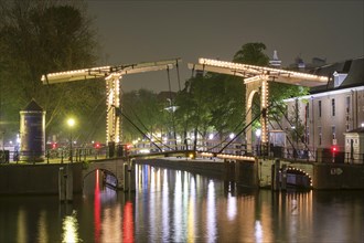 Drawbridge on the river Amstel at night