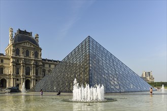 Glass pyramid and fountain in the courtyard of the Palais du Louvre