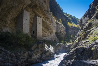 Chechen watchtowers under overhanging cliff on the Argun river
