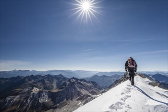 Mountaineer descending via the summit ridge from Mt Hoher Weisszint