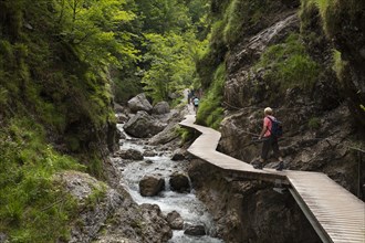 Hikers on footbridge through the Griessbachklamm gorge