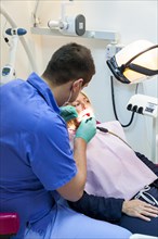 A customer is treated professionally in a dentist's surgery for inexpensive treatment for dentures