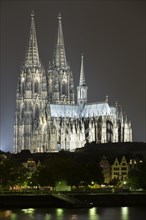 The Cologne Cathedral illuminated at night with Rhine