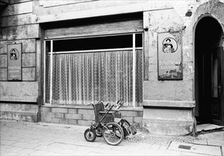 Empty disabled wheelchair in front of a restaurant in Dunkerstrasse