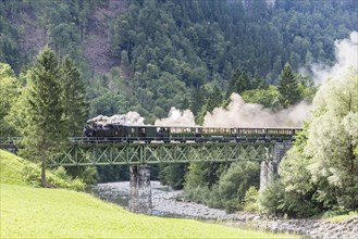 Bregenz Forest Railway with steam locomotive crossing steel bridge