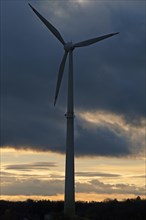 Wind turbine in front of evening sky