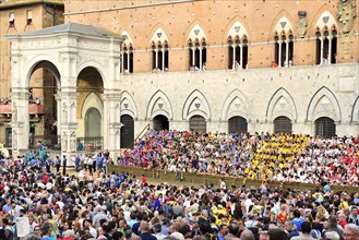 Crowds in front of the Palazzo Publico on a training day of the historical horse race Palio di Siena