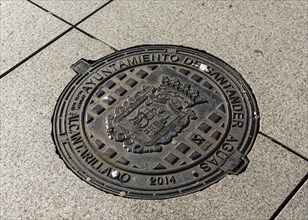 Manhole lid with coat of arms of city of Santander