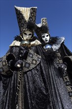 Venetian Carnival masks and costumes at the Venetian Fair on the historic market square
