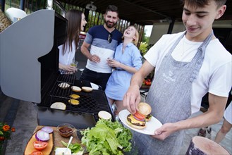 Young people grilling burgers