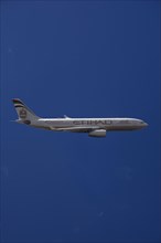 A6-EYK Etihad Airways Airbus A330-243 in flight against a blue sky