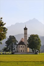 The baroque Coloman Church against the Schwangau Mountains