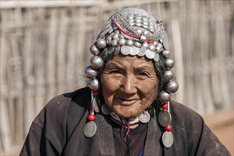 Elderly woman of the Akha ethnic group with traditional headdress