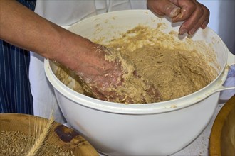 Female farmer kneading bread dough