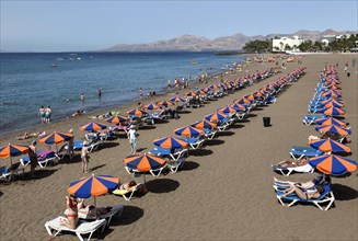 Playa Blanca beach with parasols and sun loungers