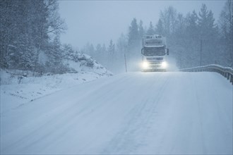Truck driving on snowy road