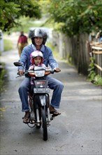 Man with child on a motorcycle