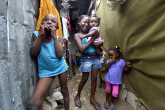 Four children in the entrance of a shack