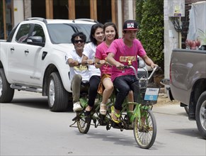 Four teenagers riding a tandem