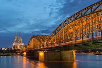 Cologne Cathedral with Hohenzollern Bridge and Cologne Philharmonic Hall at dusk