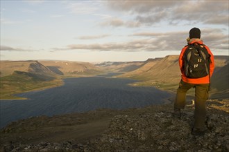 Woman looking across Dyrafjordur Fjord