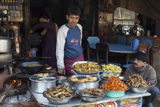 Nepalese restaurant with cooker and displayed food