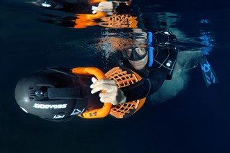 Freediver with an underwater scooter