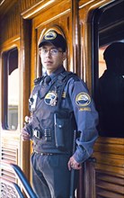Security officer in a carriage of the Andean railway Nariz del Diablo or Devil's Nose