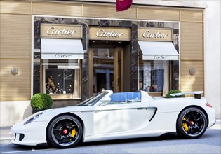 Porsche Carrera GT parked in front of the Cartier jewelry store