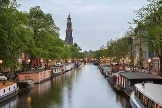 Prinsengracht canal at dusk with Westerkerk in distance