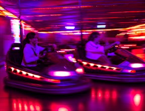 Two bumper cars at night