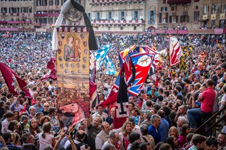 The winning team of the Palio di Siena is awarded a banner of painted silk