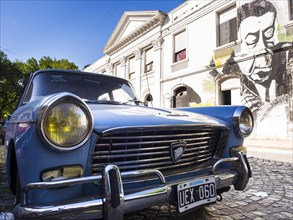 Oldtimer in front of a facade with graffiti