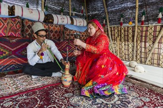 Qashqai couple smoking a water pipe in a tent