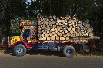 Brightly painted truck loaded with logs