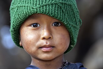 Nepalese boy with a green cap