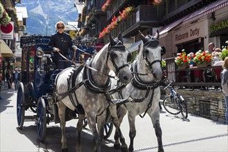 Horse-drawn carriage in Zermatter Bahnhofstrasse street