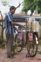 Mobile tea and coffee seller with his bike