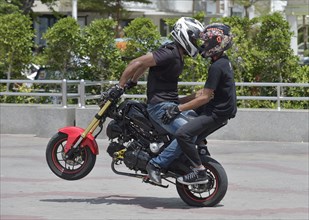 Motorcycle stunt rider performing