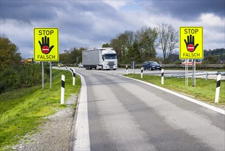 Two German signposts indicating not to enter the highway in the wrong direction