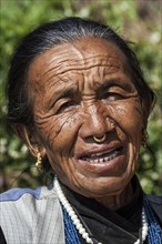 Nepalese woman with earrings and nose piercing