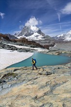 Hiker at glacier lake on the way to the Gandegg hut