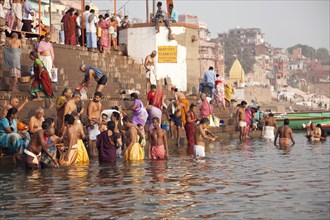 Hindu believers having a bath in the Ganges river in the morning
