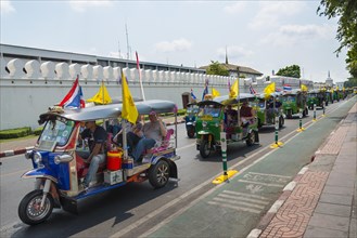 Tuktuk taxi convoy in the street