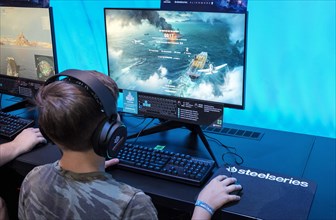 Boy plays the game World of Warships at Gamescom