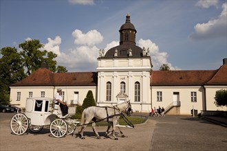 White carriage in front of the castle
